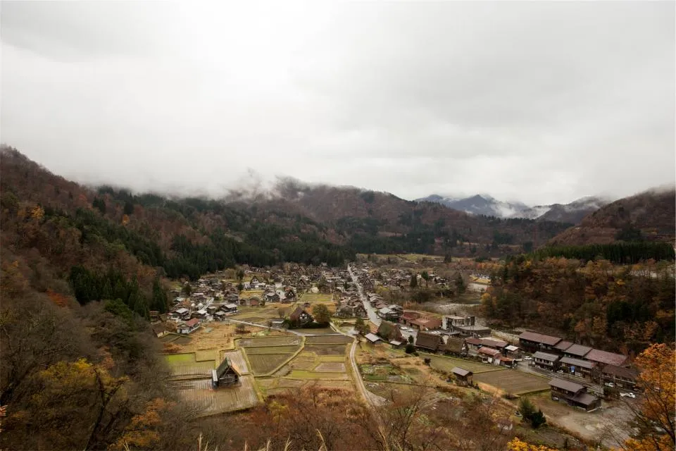 Mountain valley village with farm plots and old thatched houses in Japan